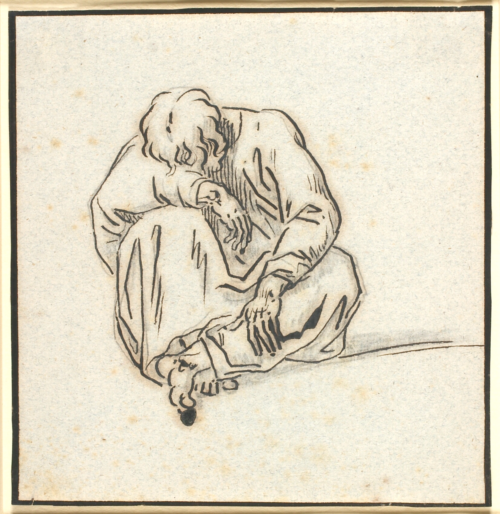 En siddende sammenkrøben mandsfigur