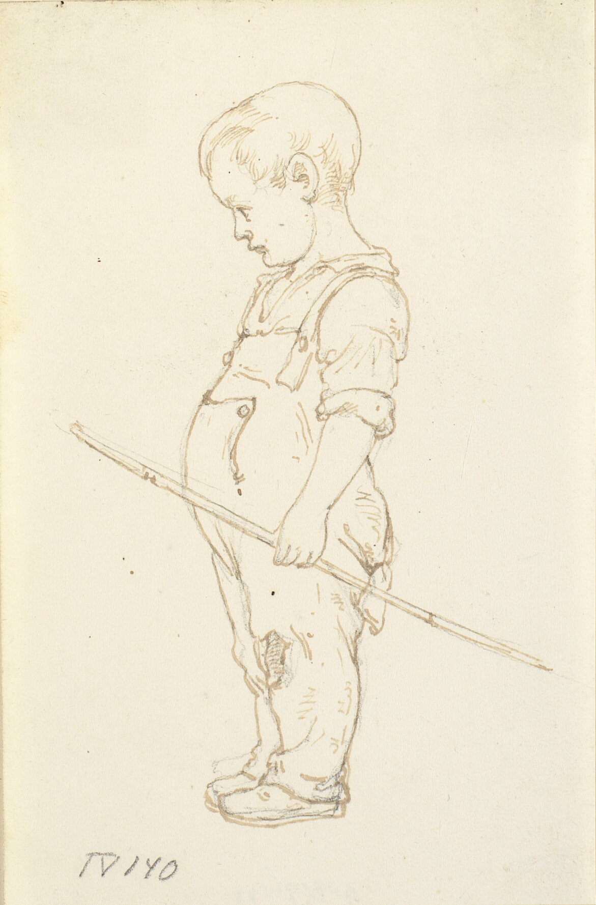 Stående lille dreng med en kæp i hånden