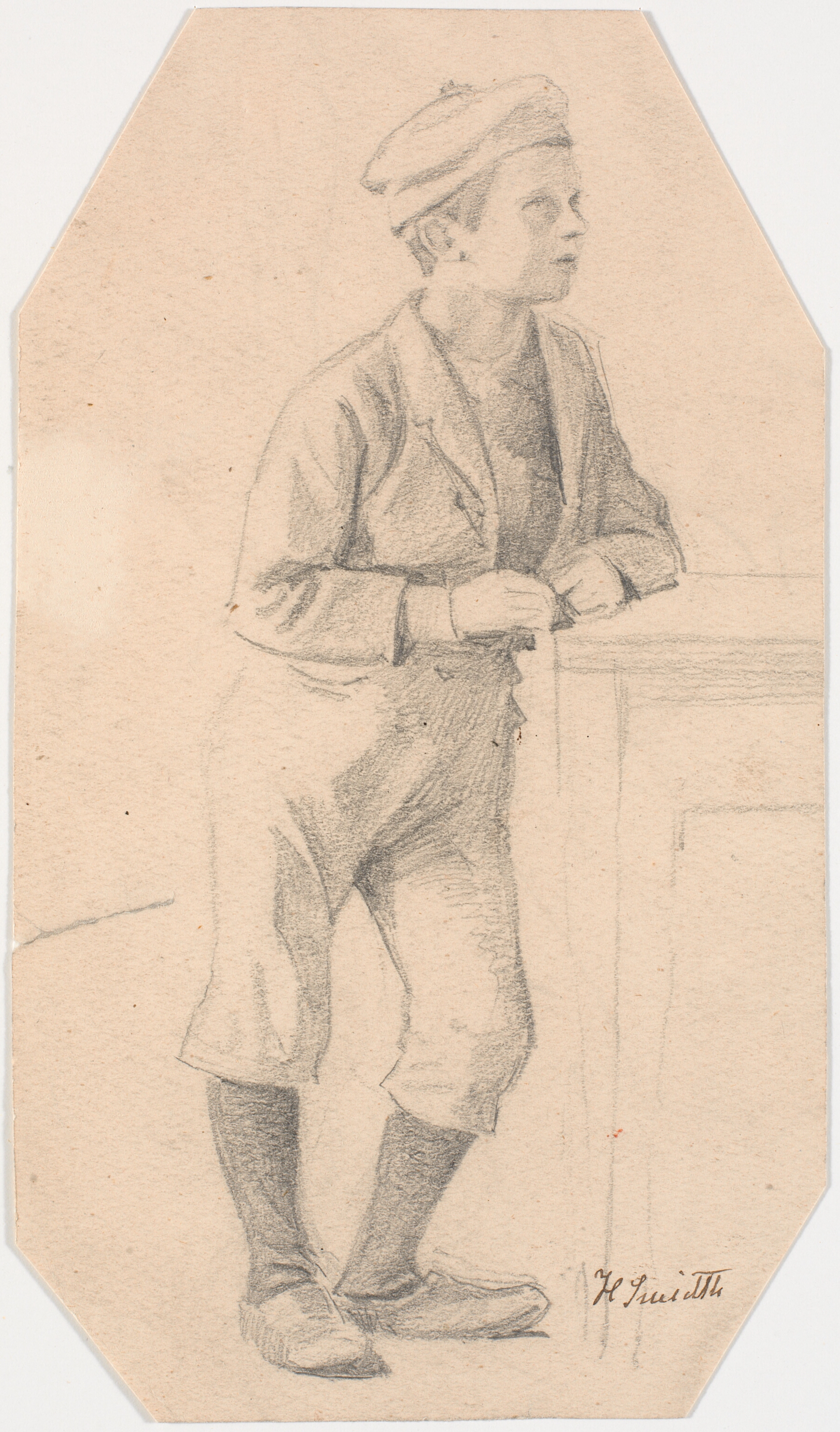 Dreng, der læner sig mod et bord