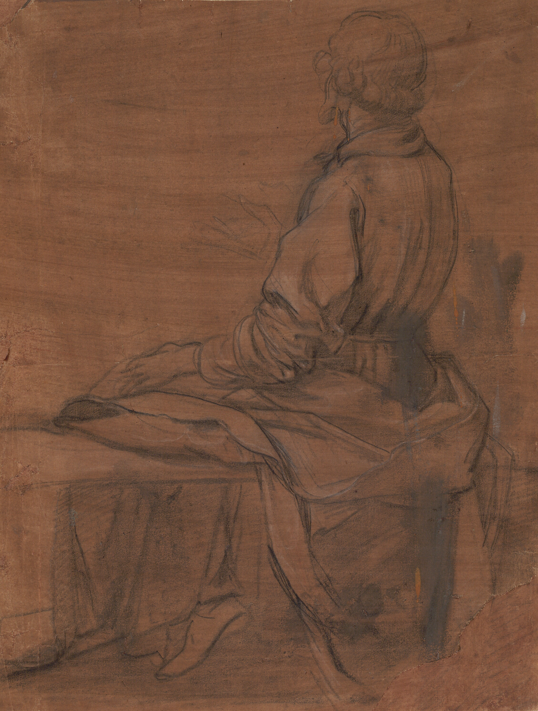 Siddende mand set bagfra