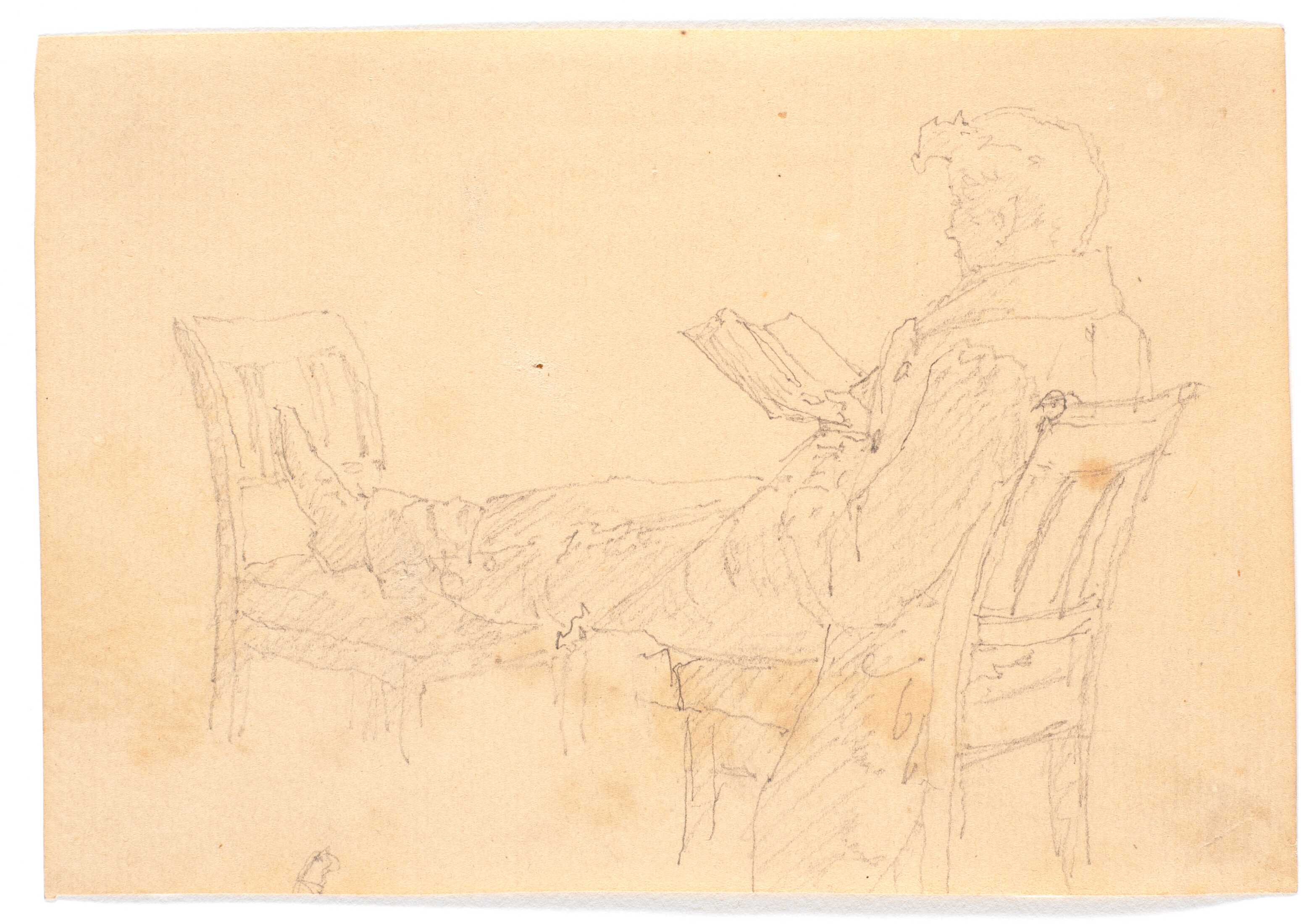 Hans Peter Købke liggende på to stole, læsende.