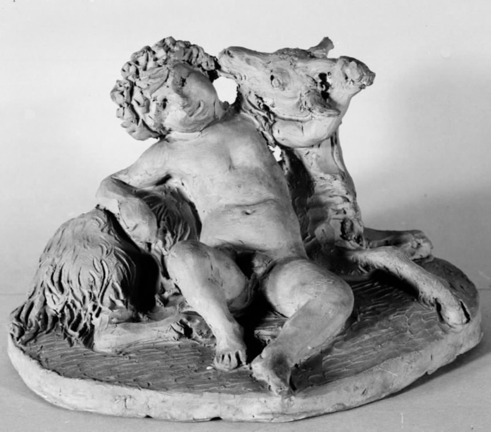 En lille dreng og en ged. Nøgen dreng med en løvkrans om hovedet sidder lænet til en liggende ged